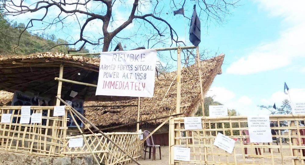 In this file photo taken December 2021, a banner demanding repeal of the AFSPA is seen alongside placards and black flags at the entrance of a community Morung at the Naga Heritage Village, Kisama, the main venue of the Nagaland’s annual Hornbill Festival. The 2021 edition of festival was officially cancelled midway as a mark of respect to victims of Oting incident and in solidarity with the bereaved families. (Morung File Photo)